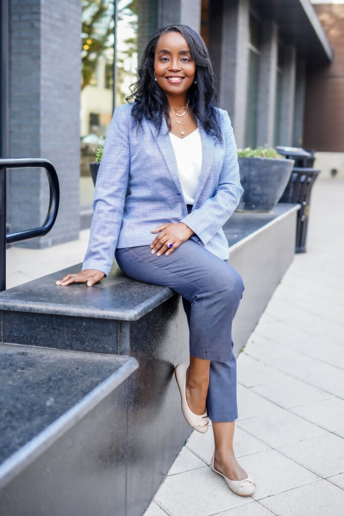 Dallas Photography for Professional LinkedIn headshot of a businesswoman in a navy blue blazer with a neutral background.